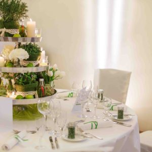 26006803 - beautiful table set  for green wedding or event party, indoors with big flower and candle arrangement